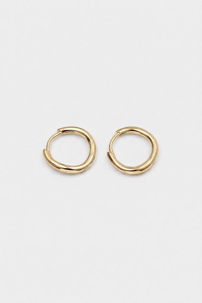 A pair of gold-toned, twisted hoop earrings shown on a plain light gray background.
