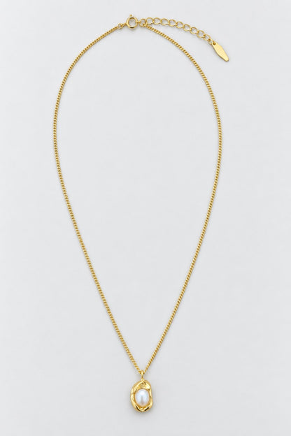 A delicate gold chain necklace with a textured gold pendant cradling a single white pearl, displayed on a clean light gray background.