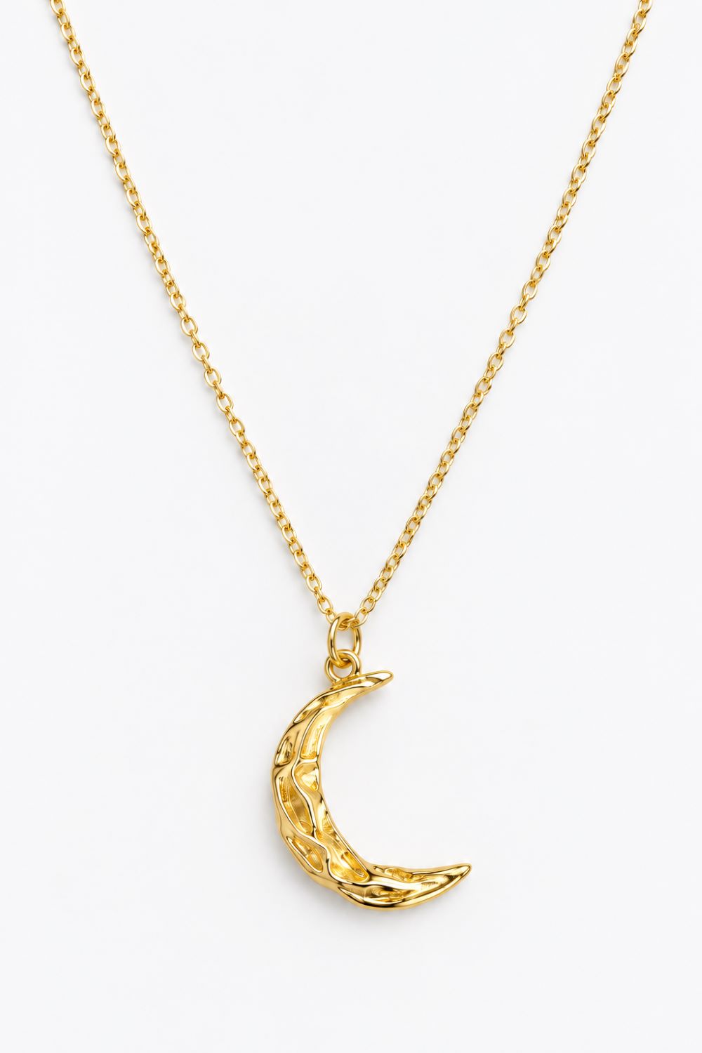 A gold chain necklace featuring a textured crescent moon pendant, displayed against a clean white background.