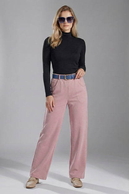 Woman wearing a black turtleneck and pink pants